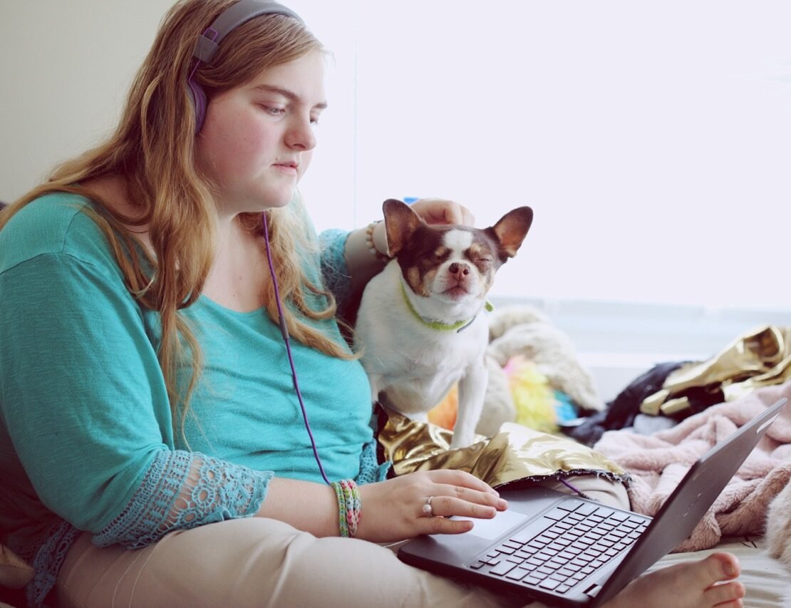 women with dog on computer