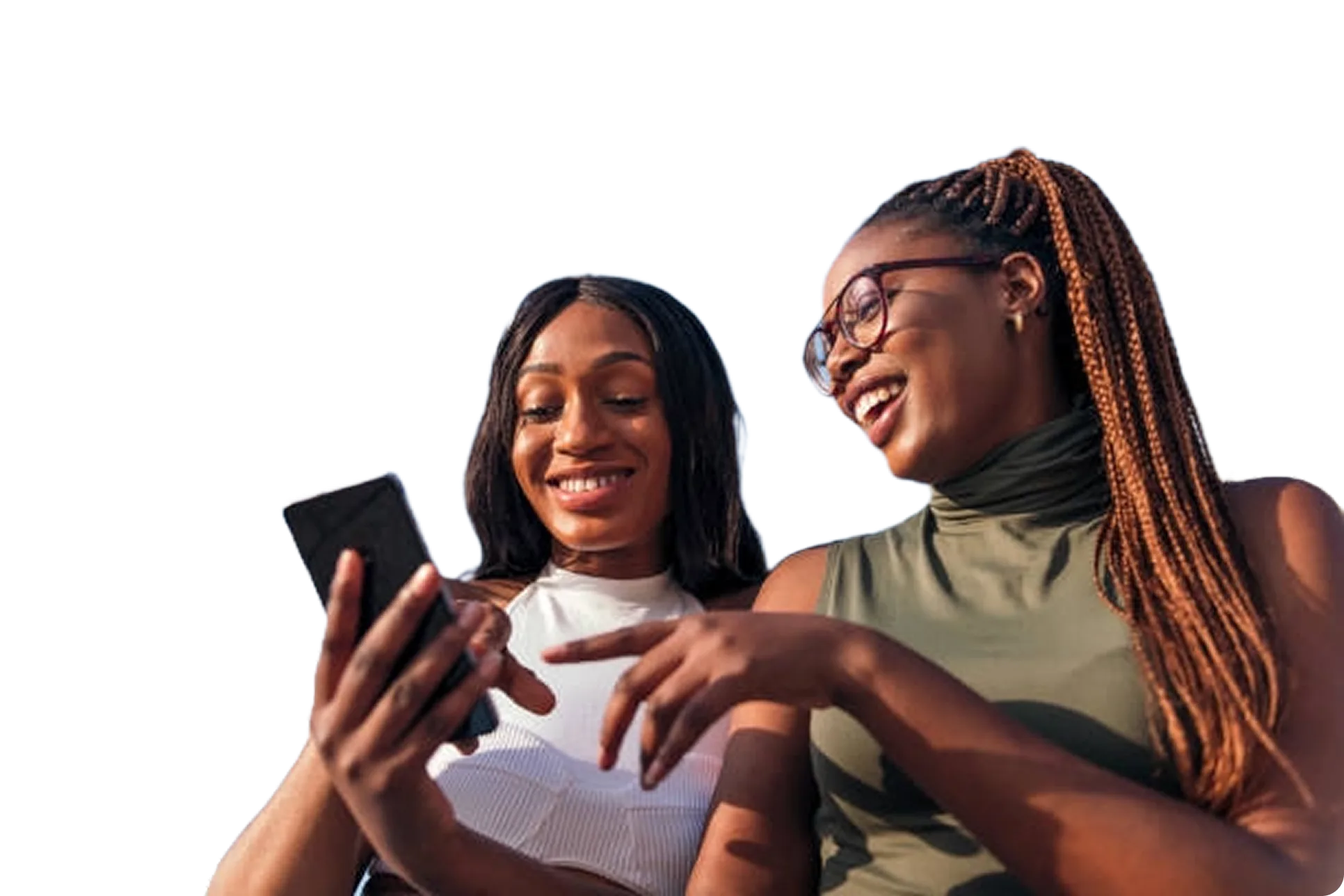 Two smiling women looking at a smartphone together, enjoying a moment of conversation