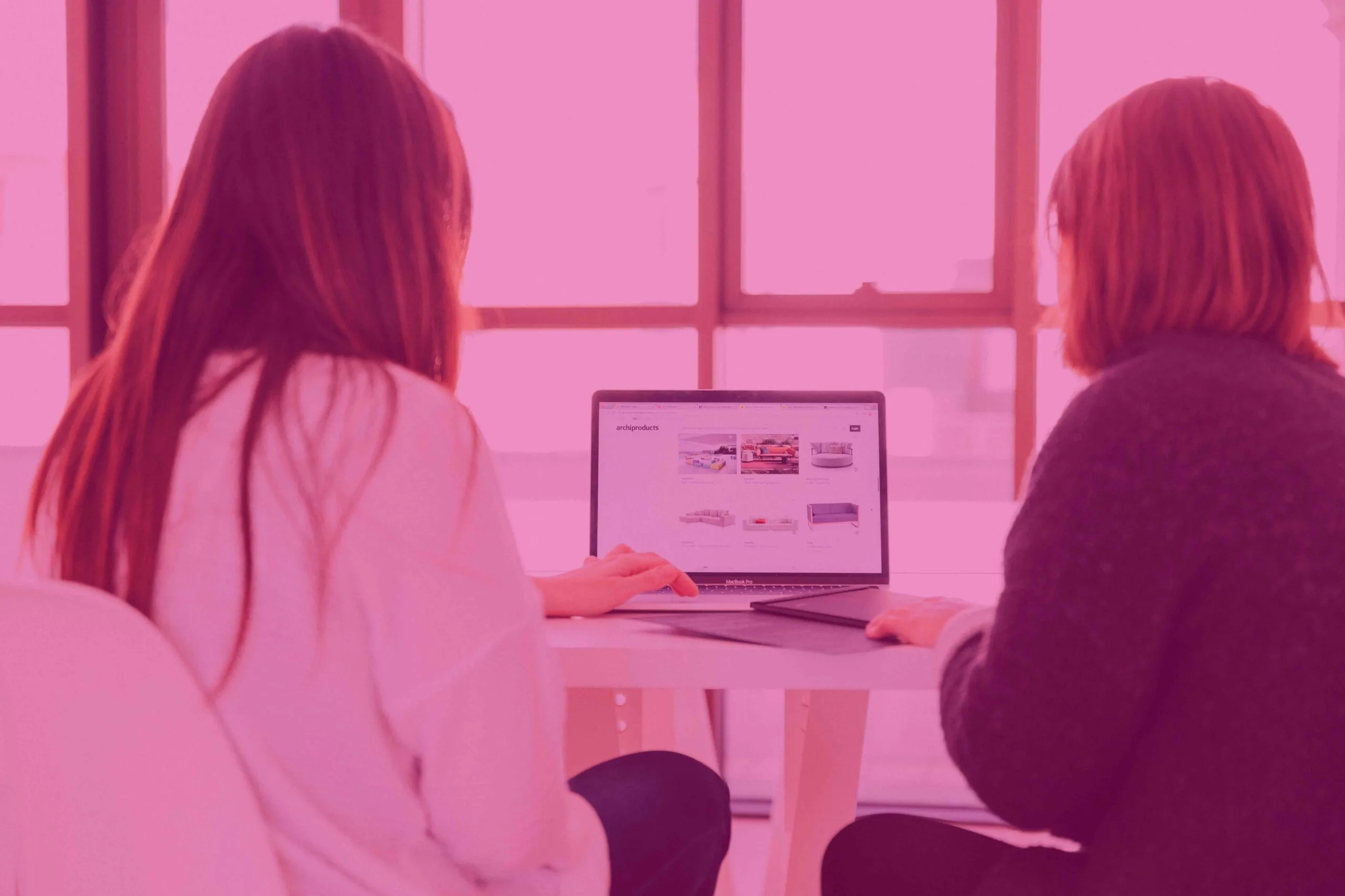 Two people looking at a computer.